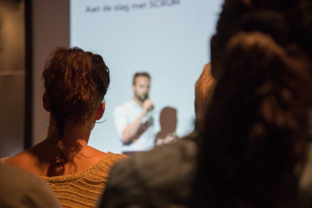 Person delivering a presentation Speaker presenting a presentation